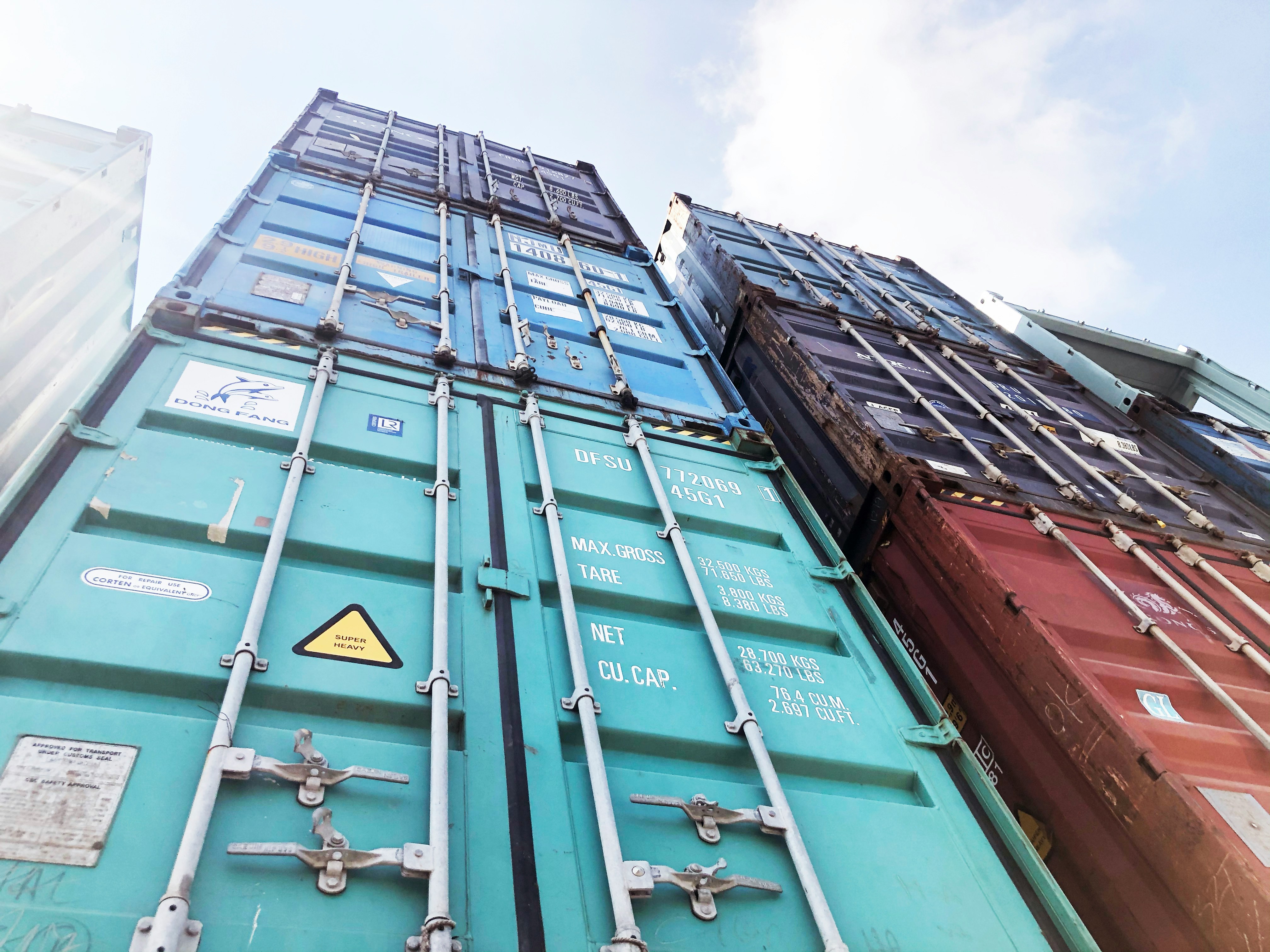 Shipping containers stacked at a logistics yard